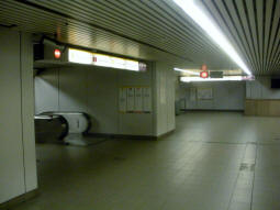 Escalators and stairs to the platforms from the concourse, westbound nearest and eastbound in the background