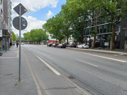 The stop from the eastbound side. The tramway runs in the middle of the street here, but the road has been raised either side so there's still step-free access to trams
