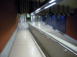 Looking down a ramp from one of the exits to the mezzanine/ticket hall and some toilets (on the right)