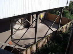 Looking down from the street to the area at the bottom of the lift to the platform for trams to Manchester