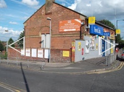 View of the station with the entrance to the stairs to the platform for trams to Manchester on the left