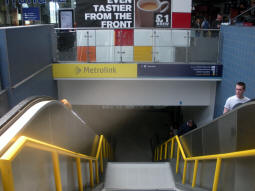 Looking down the stairs from the railway station concourse to the Metrolink mezzanine level