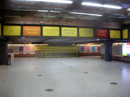 Looking across the mezzanine to the stairs down to platform B for trams to Ashton-under-Lyne from by the lift and stairs down to platform A