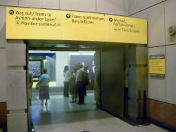Looking towards platform A for trams via Piccadilly Gardens from by the escalator and stairs up to the mezzanine level