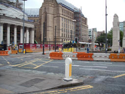 Looking at the station from across the street as a tram to Altrincham leaves