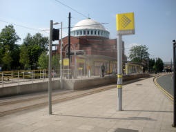 The station from near the railway station, with the platform for trams to Manchester nearest