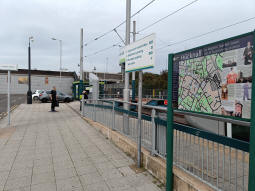 In between the car park on the left and the platforms