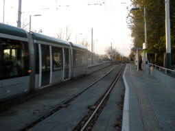 The platform for trams to the city centre with a tram entering the other platform