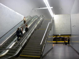 The stairs and escalators that make up one of the exits from the south-eastbound platform, which is in the lower background
