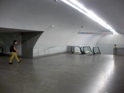 The stairs and escalators down to the north-westbound platform can be seen from the top of the stairs and escalators down to the other platform (seen in previous photo). Escalators up to one of the ticket halls are off to the left