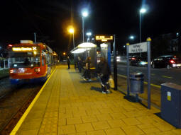 The platform at night with a tram going out of service into the overrun track (not sure why)