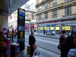 On platform 1 for trams to Edgbaston Village. The time until the next tram arrives is shown in tiny text on this screen