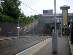 From platform 3 for trams to Wolverhampton the stairs up from platform 4 and the station footbridge can be seen
