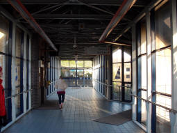 On the station footbridge, on the left, the lift down to one of the railway station's platforms and the Metro stop, on the right stairs down to the same places, and straight ahead is an exit by which is a staircase down to the other side of the Metro stop